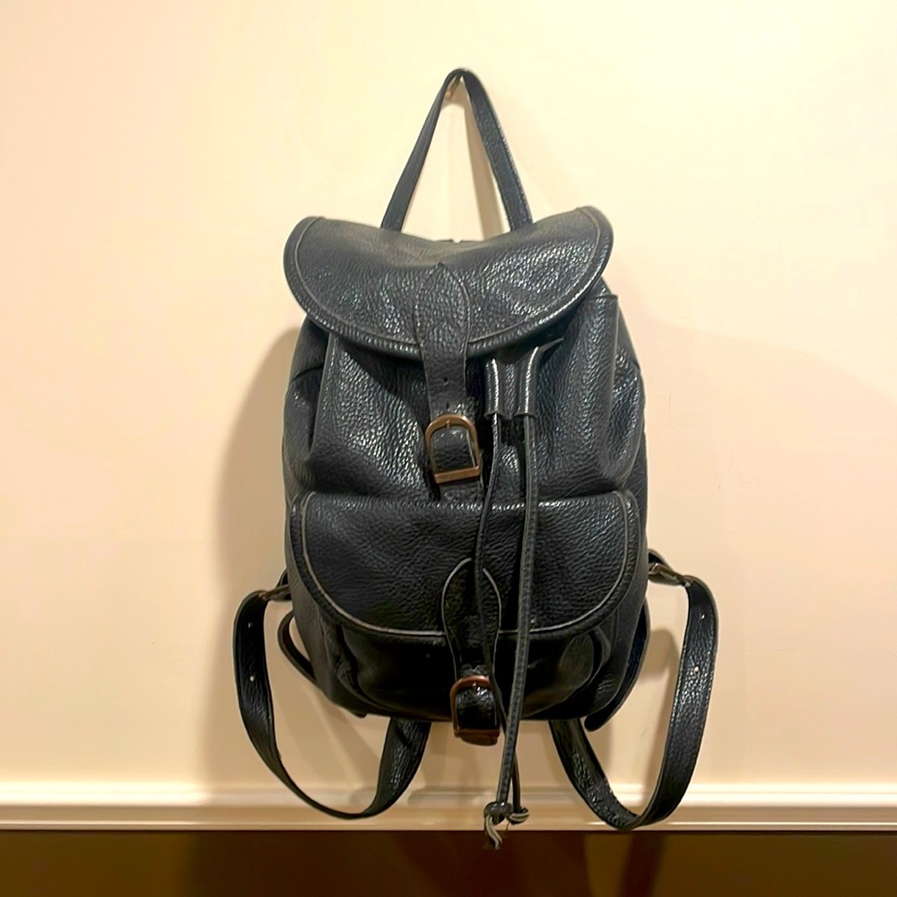 Black genuine leather backpack, 15”T x 13”W x 6”D. Good condition.